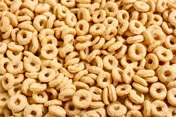Tasty cereal rings as background, closeup