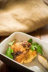 baked chicken fillet pieces with spices and herbs, in a ceramic form