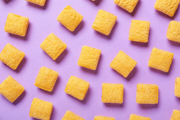 Tasty corn pillows on color background, closeup