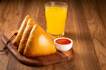 Arabic meat sfiha with juice cop on the table.