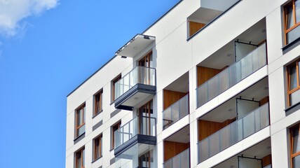 Fragment of modern luxury residential apartment,  home house building concept. Modern apartment building on a sunny day with a blue sky.