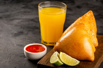 Arabic meat sfiha with juice cop on the table.