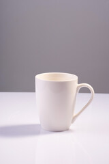 empty white cup on white gray background minimalistic concept