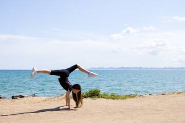Fototapeta na wymiar girl doing exercise on the beach