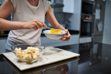 Obraz na płótnie Canvas Woman whisking eggs for a banana pancake recipe