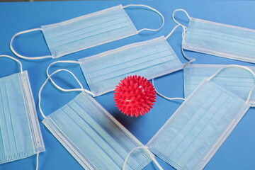 Viral Coronavirus Bacteria And Protective Medical Disposable Masks On A Blue Background. Concept Of...