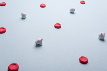 medical flatlay red and white blood cells. Red blood cells and leukocytes on a blue background.