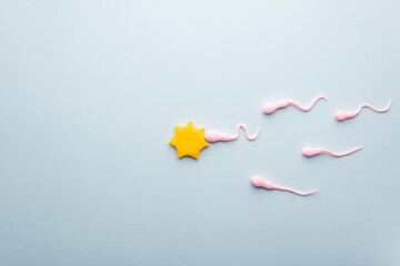 active sperm fertilize the egg. Medical flatlay on a blue background. illustration on the theme of fertility.