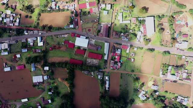 Aerial view of houses and harvest fields in the village