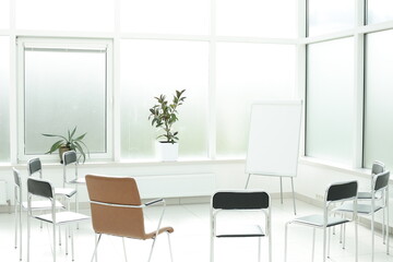 Flipchart and chairs in a bright office space