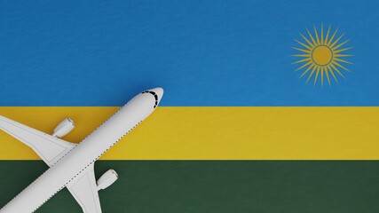 Top Down View of a Plane in the Corner on Top of the Country Flag of Rwanda - obrazy, fototapety, plakaty
