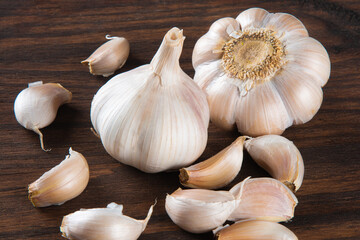 Garlic Cloves and Bulb isolated on wooden background.