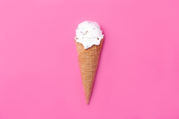 Ice cream in a waffle cone on a pink background. Ice cream with chocolate chips and vanilla flavor