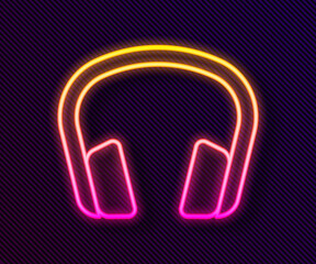 Glowing neon line Headphones icon isolated on black background. Earphones. Concept for listening to music, service, communication and operator. Vector