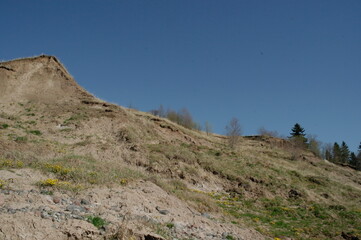 The top of the hill against the blue sky