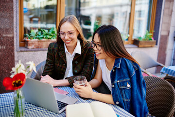 Satisfied women watching video on laptop