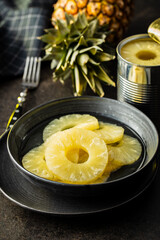 Canned sliced pineapple fruit on plate.