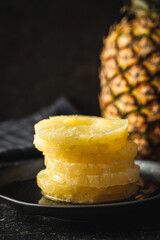 Canned sliced pineapple fruit on plate.