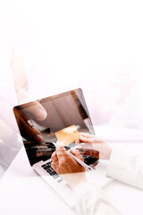 male hands holding a credit card and use mobile phone for Online payment online shopping