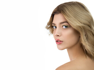 Fototapeta premium Beautiful young woman with perfect skin and wavy hair. Fashion model with nice professional make-up posing in the studio, isolated on white.