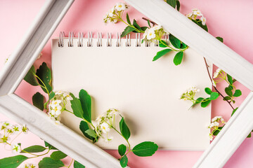 Floral composition with notepad. Flat lay, top view, copy space