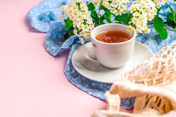 Beautiful natural spring background with space for text on a pink table with a cup of tea