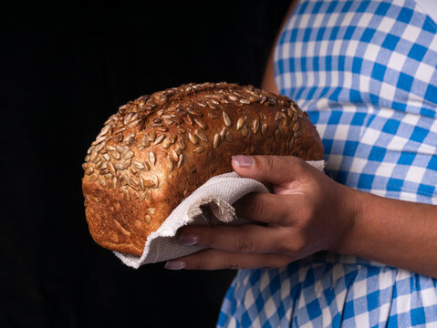 Person Holding A Loaf Of Bread