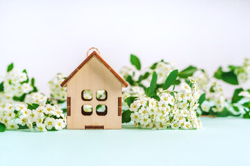 Wooden house in a floral composition, the concept of an ecological lifestyle, top view, flat lay