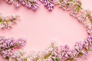 Fototapeta na wymiar Floral composition with a place for text in the form of a frame of lilac on pink background.