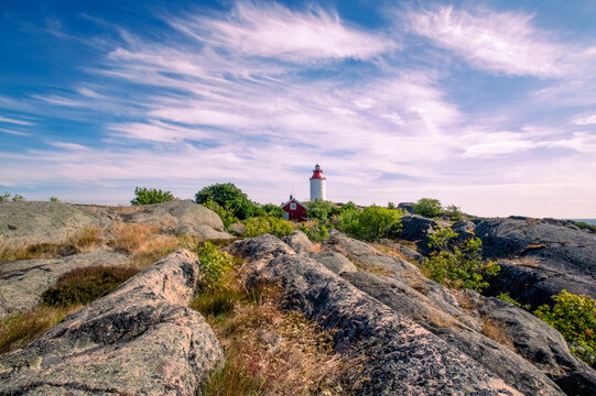 Lighthouse in the Swedish village Landsort on the island of Oja against the backdrop of a beautiful sky with clouds. Sweden, Scandinavia