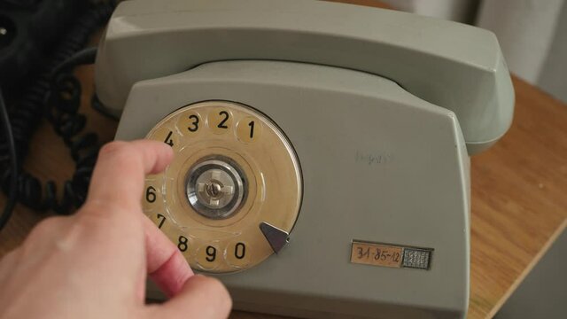 dialing a number on an old bakelite landline phone