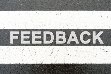 On the asphalt between the white dividing stripes the inscription - FEEDBACK