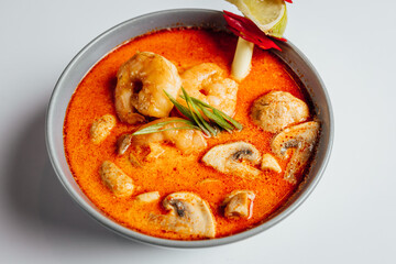 Spicy Tom Yam soup with shrimps and mushrooms on white background