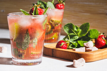 Refreshing summer drink caipirinha cocktail with strawberries and fresh mint