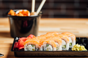 View on sushi rolls on wooden table, fresh asian food on table