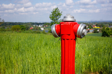 hydrant to connect water on the field, city far in the background. The concept of connections needed in agriculture or in the construction of houses outside the city