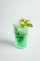 Fresh mojito cocktail in glasses on bright background with lime ant mint lefs, alcoholic cocktail.