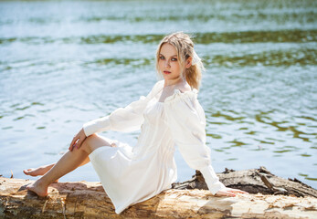 Young beautiful blonde woman in white dress, summer park outdoors