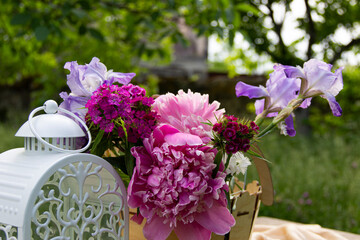 fresh flowers are placed on the table next to the lamp in a wooden vase
