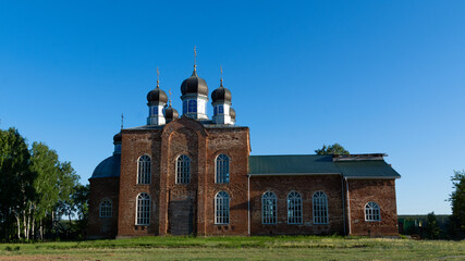 Fototapeta na wymiar old orthodox church made of brick against the blue sky.