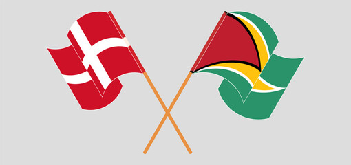 Crossed and waving flags of Denmark and Guyana