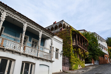 Fototapeta na wymiar Authentic Georgian houses with wooden balconies overgrown with grapes in the old center of Tbilisi, Georgia 