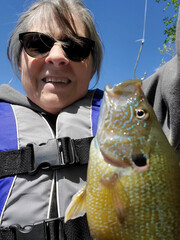 Senior woman holding fish she caught