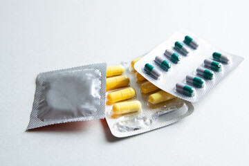pills and condom on the table