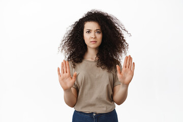 Stop this. Serious concerned woman showing no, block gesture, raising hands to disapprove and...