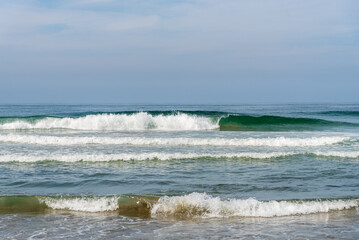 Ocean Waves Breaking on Sandy Shore in California