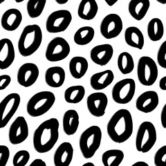 Seamless pattern with abstract black circles on white. Animal skin imitation. Texture for print, fabric, textile, wallpaper.