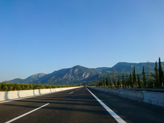 Naklejka premium Driving autobahn asphalt road in Greece, Europe. Trip from Thessaloniki to Athens. Sunset sunny clear mountains view in automobile journey