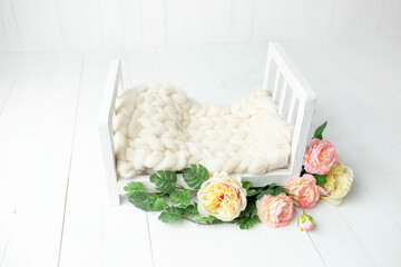 baby cot for a photo shoot of newborns. props for a photo shoot. the bed is decorated with roses. furniture for dolls