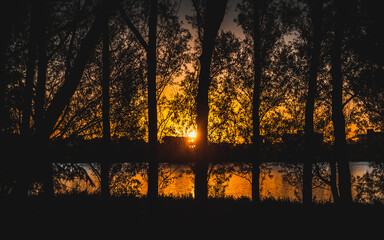 Sunset by the river and trees